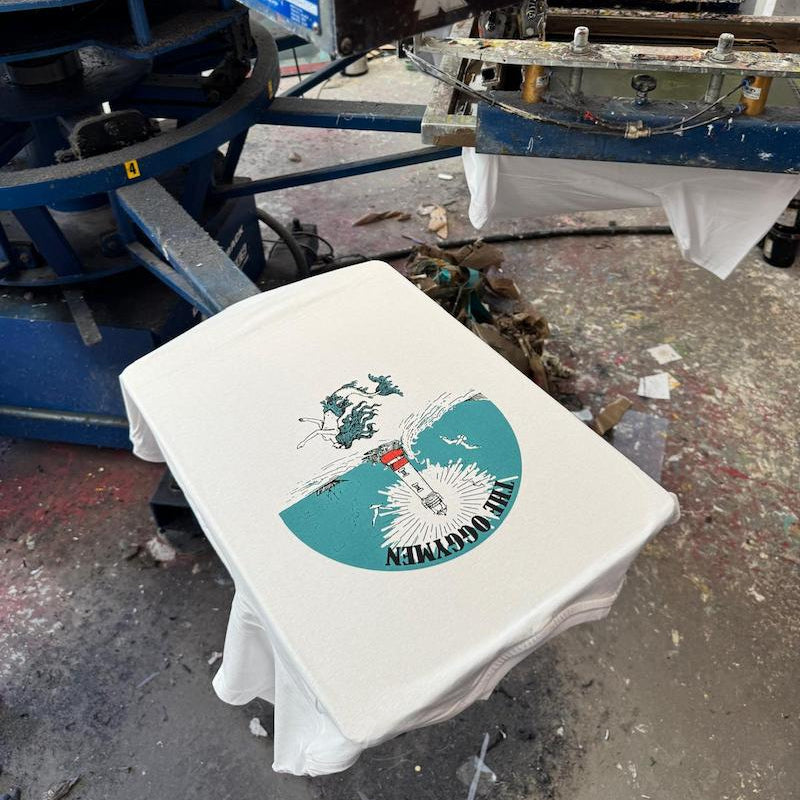 White t-shirt with a printed design on a printing machine.